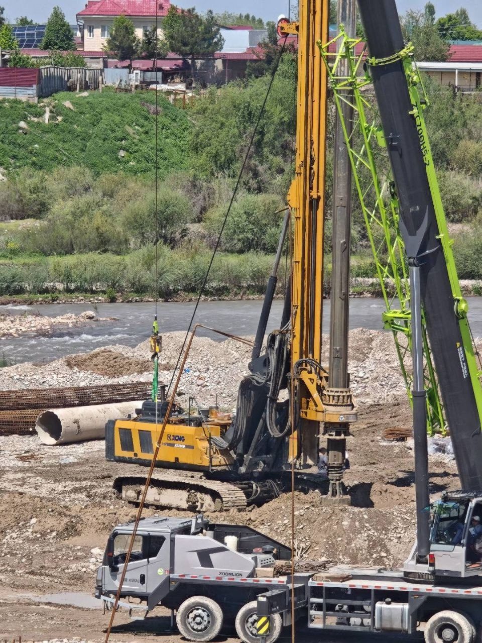 Rotary drilling rig operating beside river bank